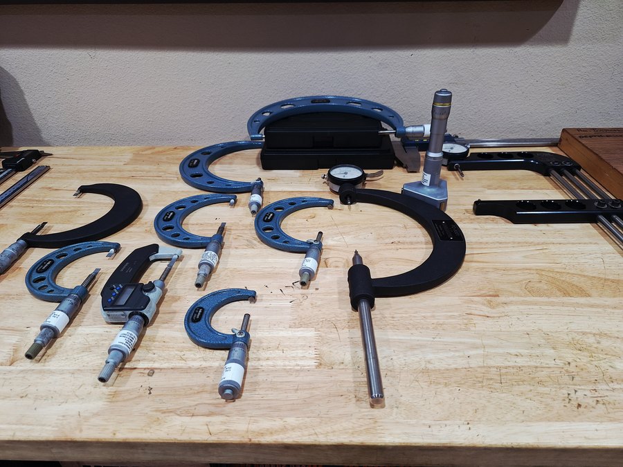 Shelves of micrometers, calipers, dial indicators and bore gauges in the inspection room